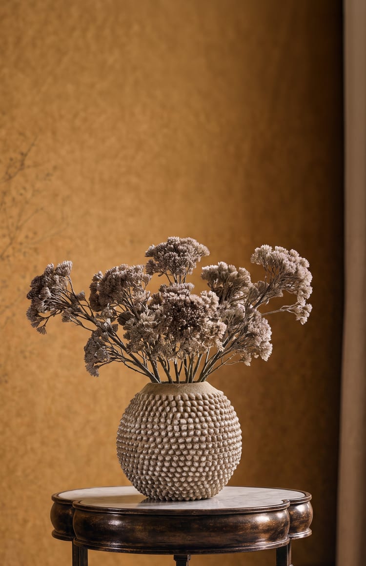 Dried florals arranged in a sculptural vase